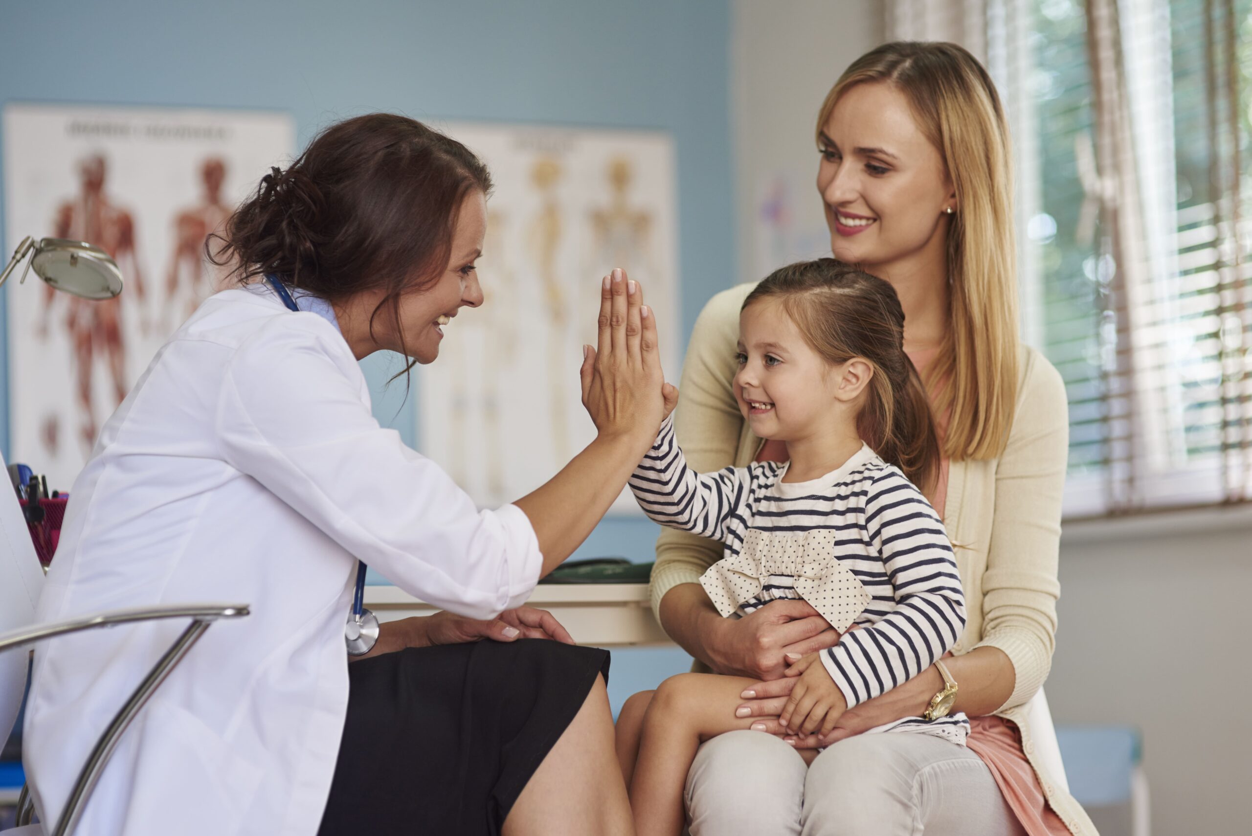 pediatra atendendo uma mãe e sua filha